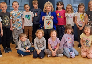 Do zdjęcia pozują dzieci z zaproszoną poetką.